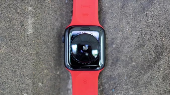 تصویری از اپل واچ SE در رنگ خاکستری فضایی با بند قرمز رنگ